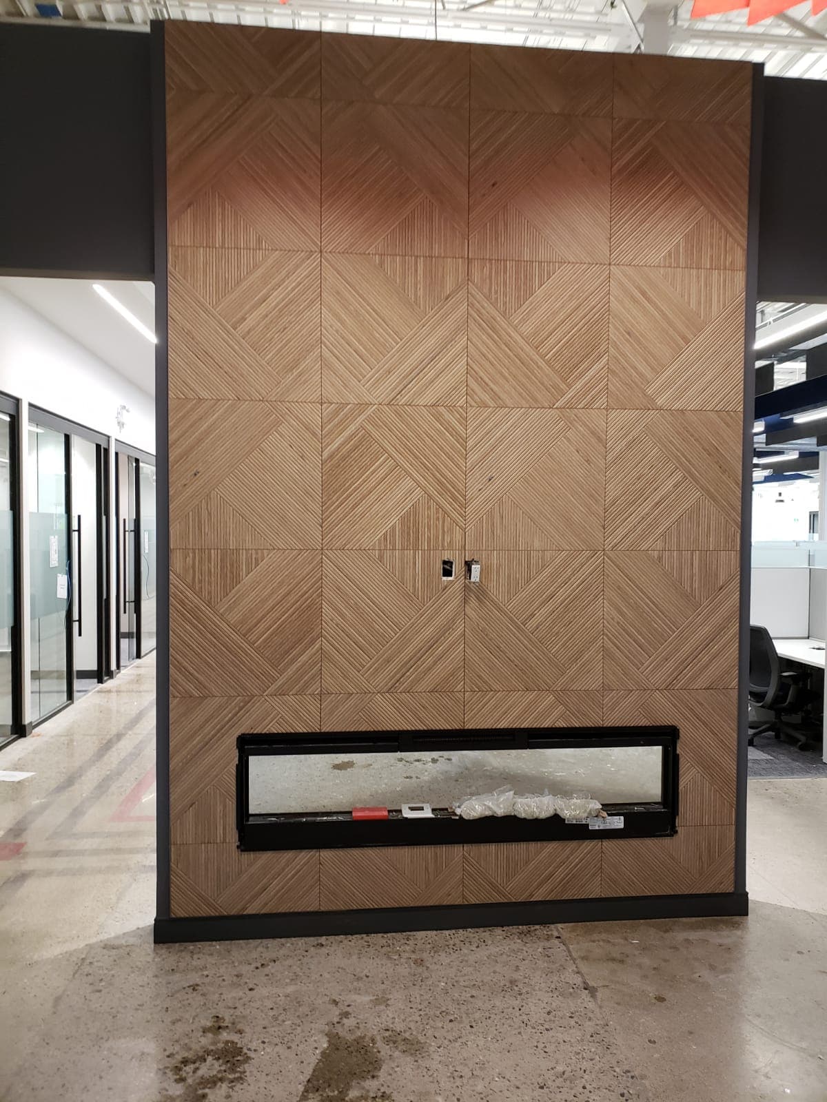 Feature wall with fireplace, built-in shelving, and wood-look tile floor